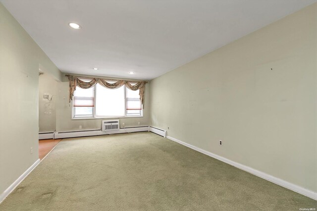 spare room with carpet floors and a wall mounted AC