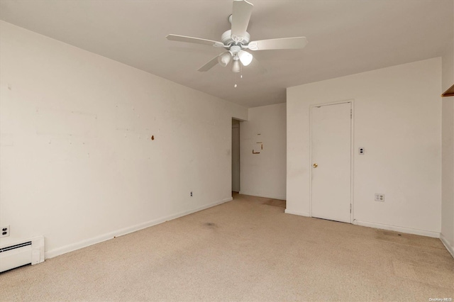 unfurnished bedroom with light carpet, baseboard heating, and ceiling fan