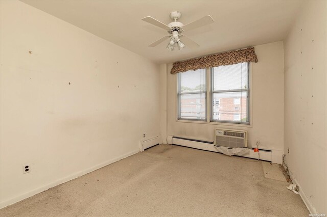 carpeted spare room with ceiling fan and baseboard heating