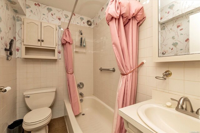 full bathroom featuring backsplash, shower / bath combination with curtain, toilet, vanity, and tile walls