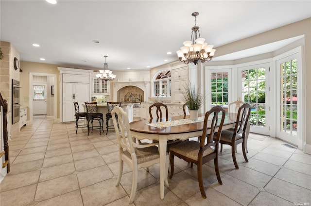 dining area featuring sink and a chandelier