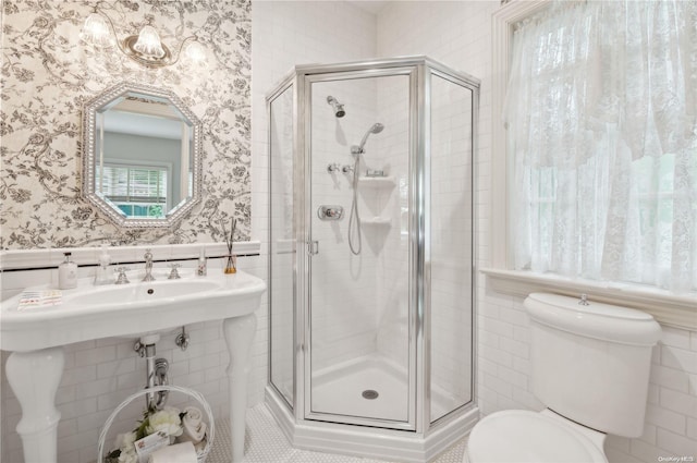 bathroom with toilet, walk in shower, and tile walls