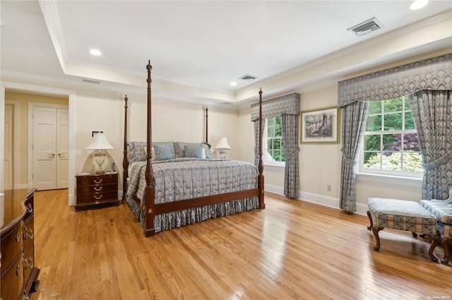 bedroom with light hardwood / wood-style flooring, multiple windows, and crown molding