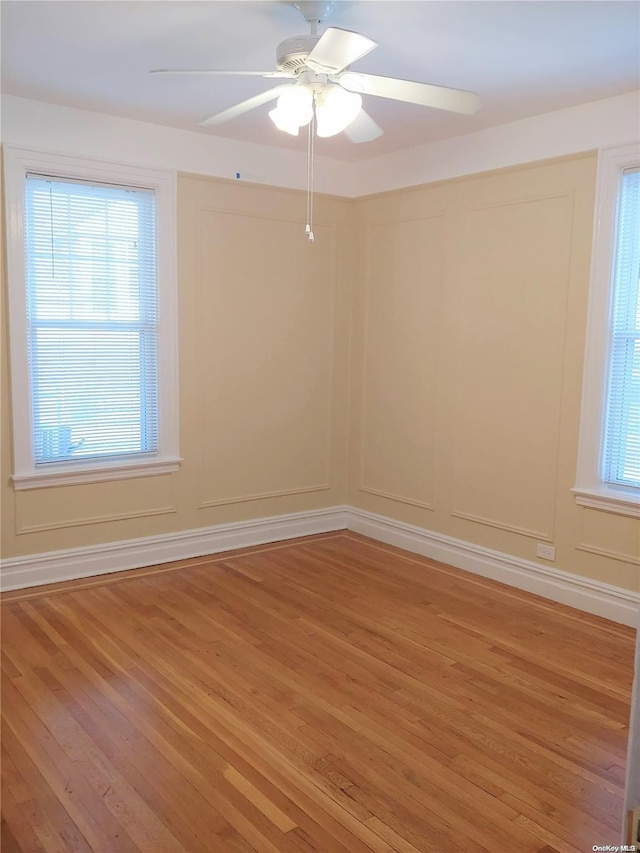 spare room featuring ceiling fan and wood-type flooring