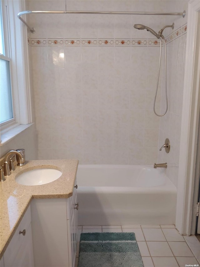 bathroom featuring tile patterned floors, vanity, and tiled shower / bath combo