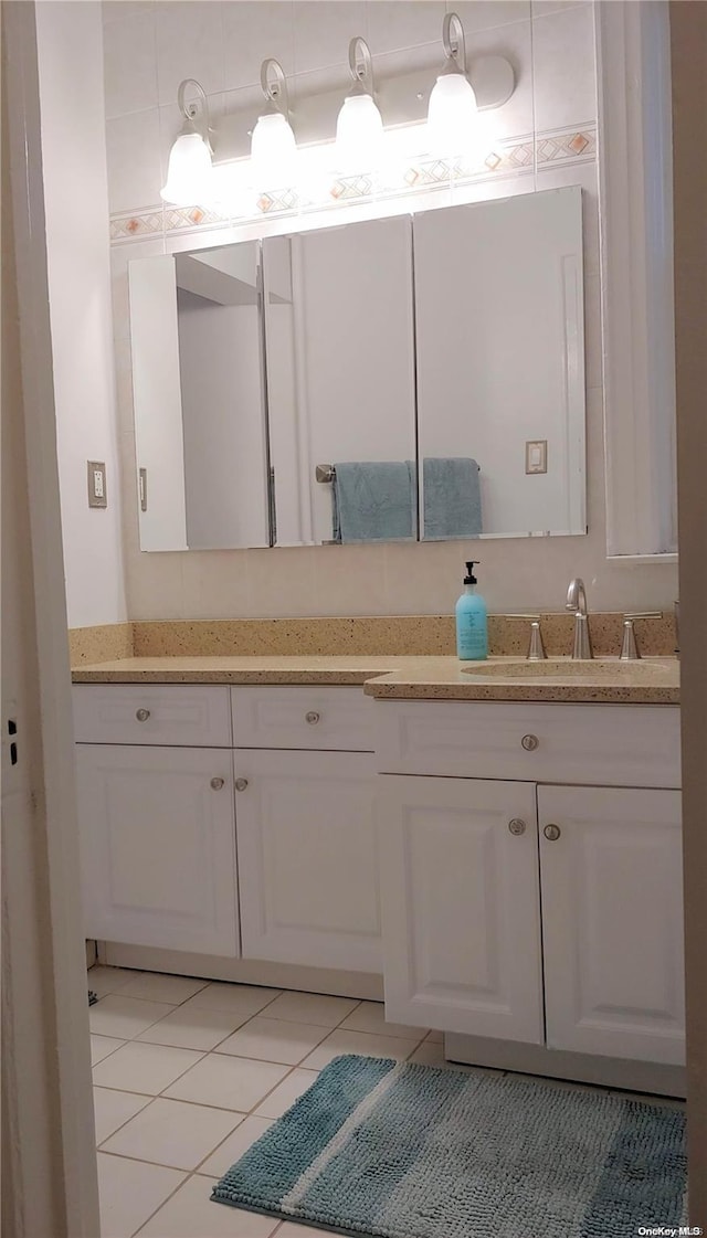 bathroom featuring tile patterned flooring and vanity