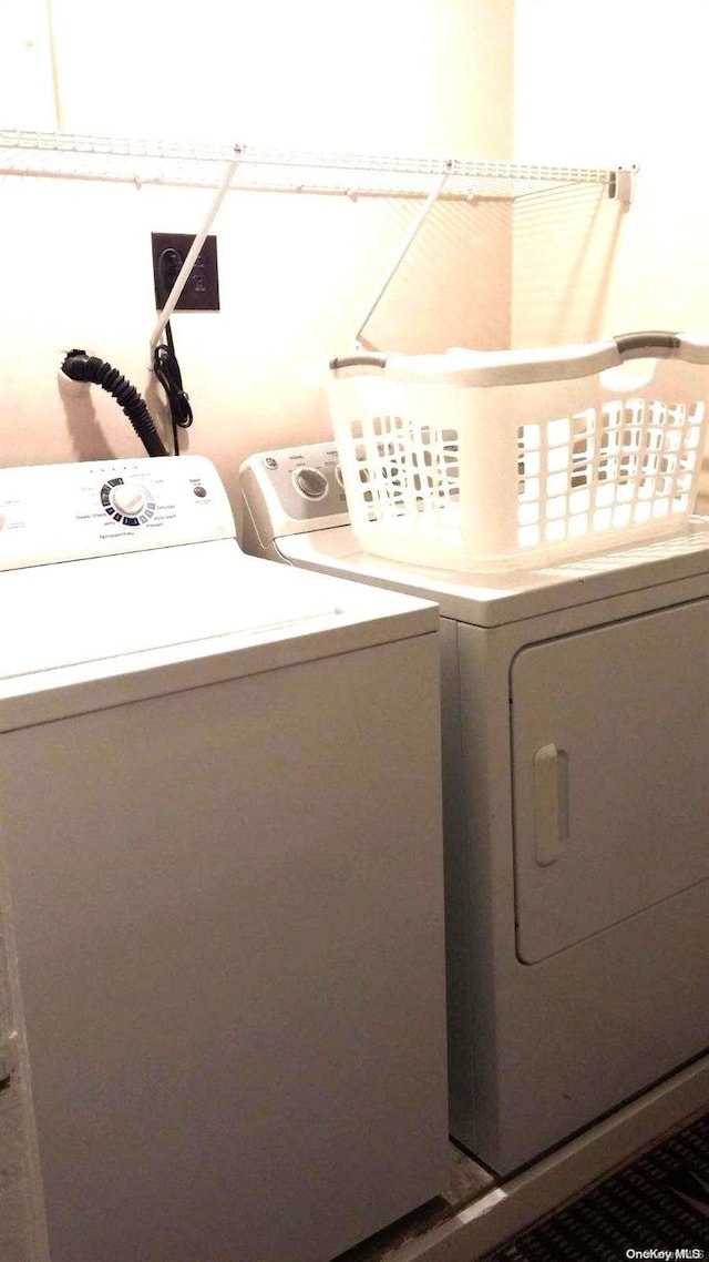 laundry area featuring washing machine and clothes dryer