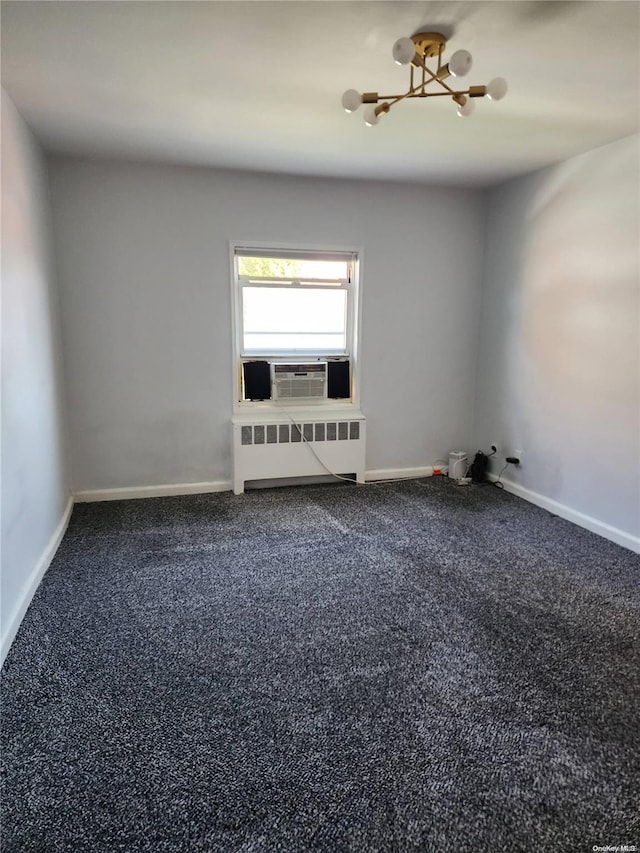 unfurnished room with carpet, a notable chandelier, cooling unit, and radiator