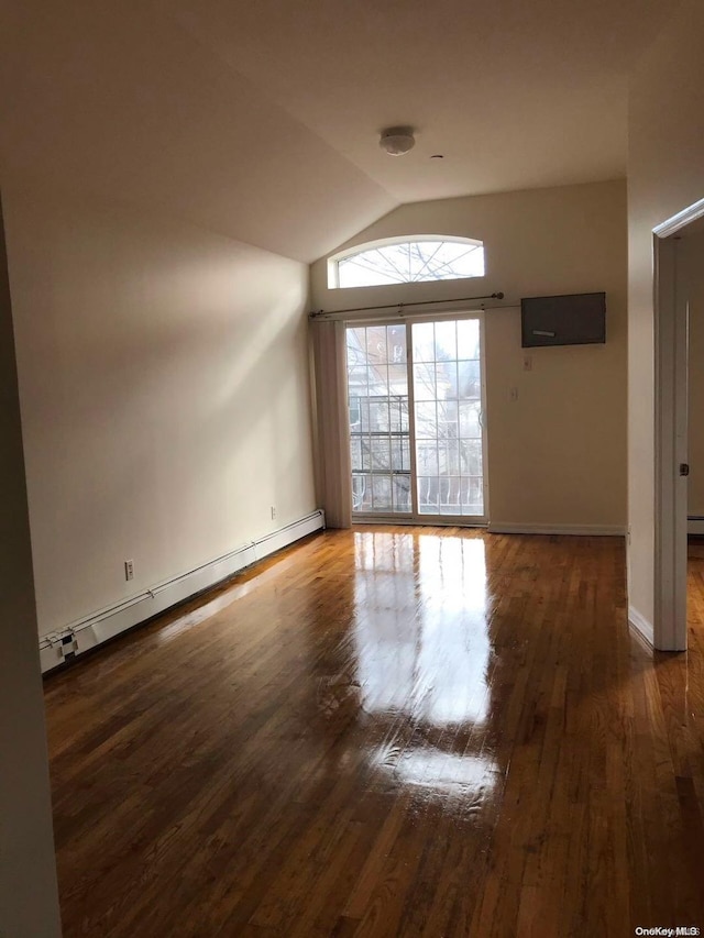 unfurnished room with vaulted ceiling, dark hardwood / wood-style flooring, and a baseboard radiator