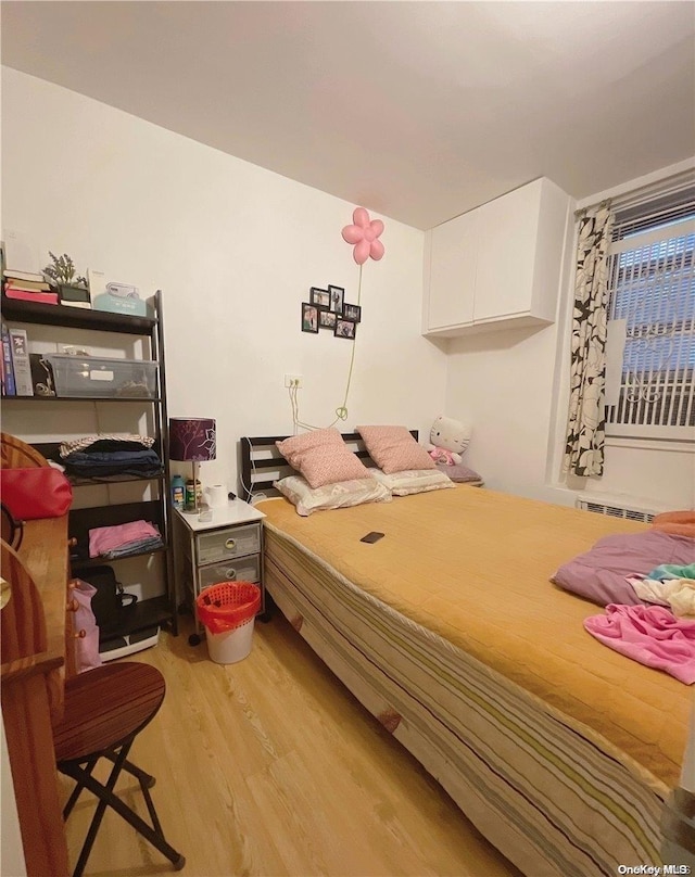 bedroom with light hardwood / wood-style floors