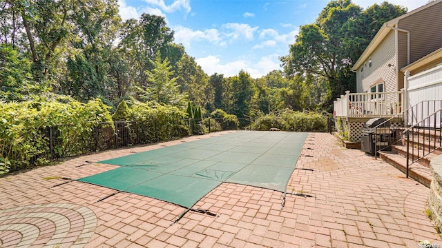 view of swimming pool with a patio area