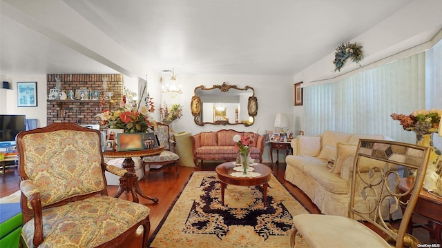 living room featuring wood-type flooring and an inviting chandelier