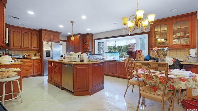 kitchen with decorative backsplash, a center island, stainless steel appliances, and hanging light fixtures