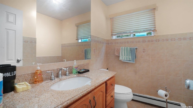 bathroom featuring tile patterned floors, vanity, a baseboard radiator, tile walls, and toilet