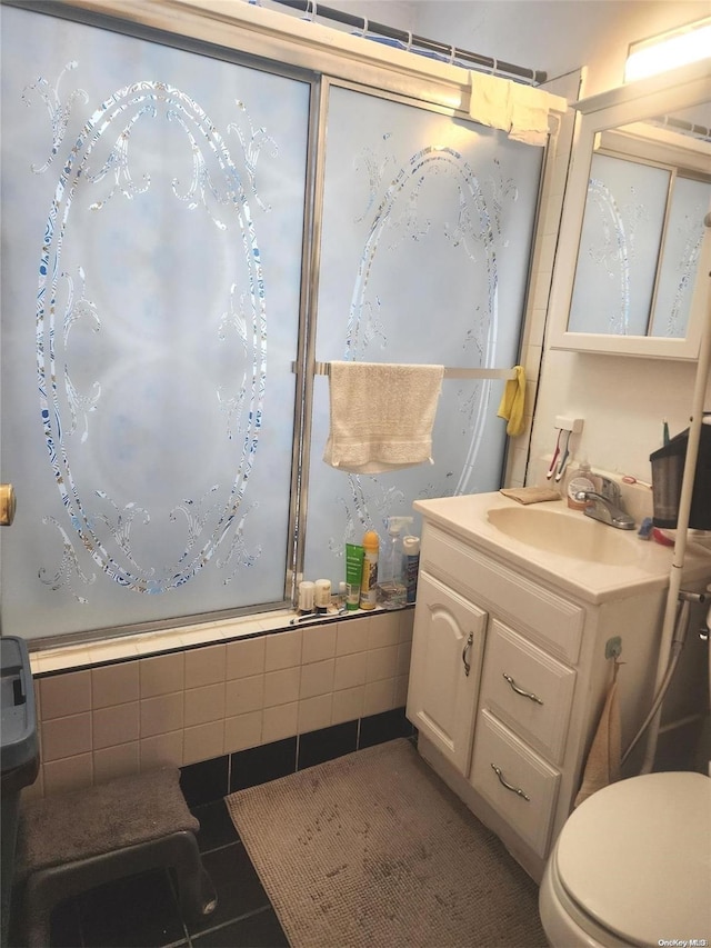 bathroom featuring tile patterned floors, vanity, and toilet