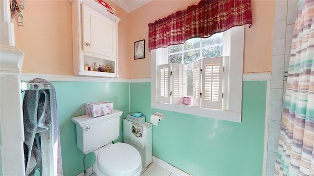 bathroom featuring toilet, walk in shower, and tile patterned flooring