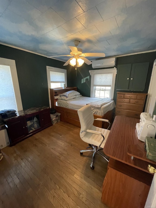 bedroom featuring a wall unit AC, ceiling fan, and wood-type flooring