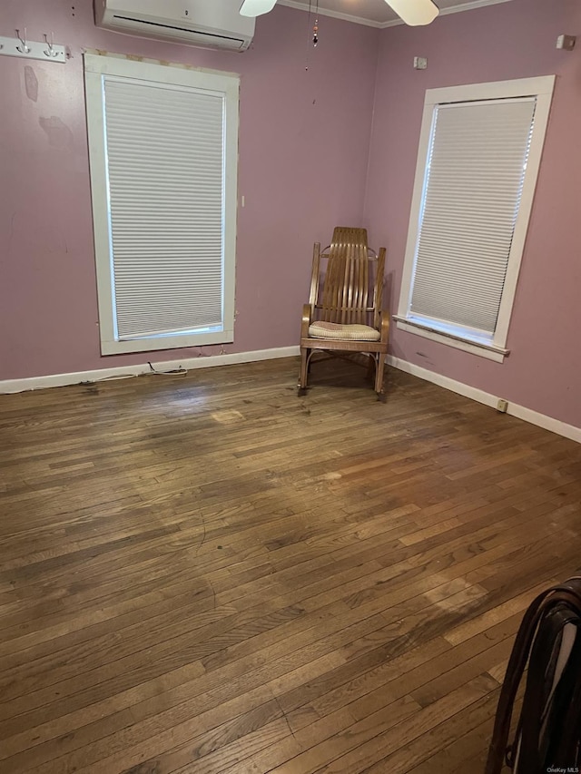 unfurnished room featuring ceiling fan, dark wood-type flooring, ornamental molding, and a wall mounted air conditioner