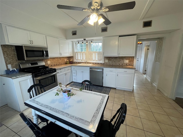 kitchen with white cabinetry, light tile patterned flooring, visible vents, appliances with stainless steel finishes, and a sink