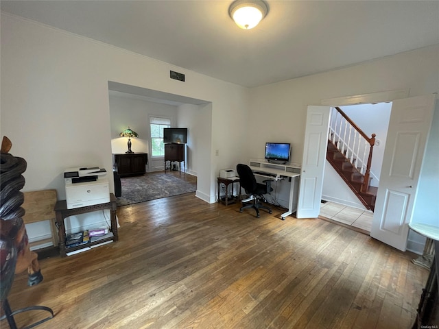 home office featuring visible vents and hardwood / wood-style flooring