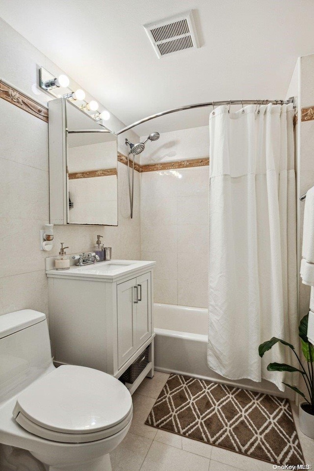 full bathroom featuring shower / bath combo with shower curtain, tile patterned flooring, vanity, and toilet