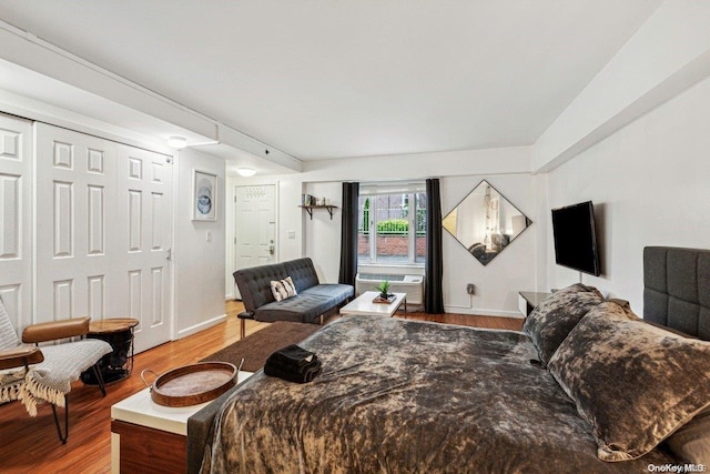 bedroom with hardwood / wood-style flooring and a closet