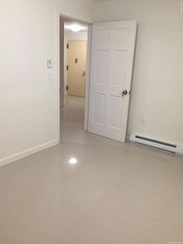 empty room featuring a baseboard heating unit