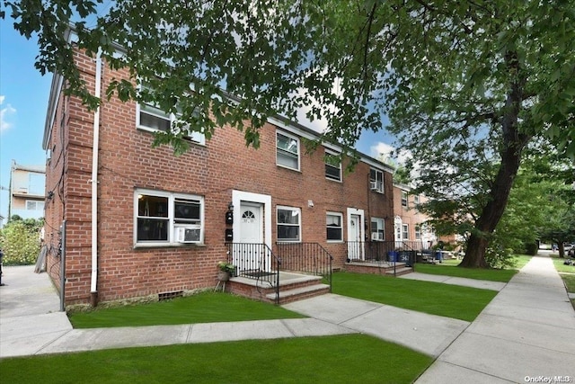 view of front of property with cooling unit and a front lawn