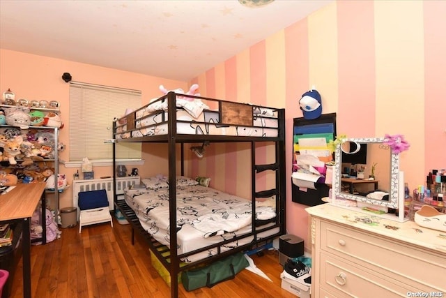 bedroom with dark hardwood / wood-style flooring