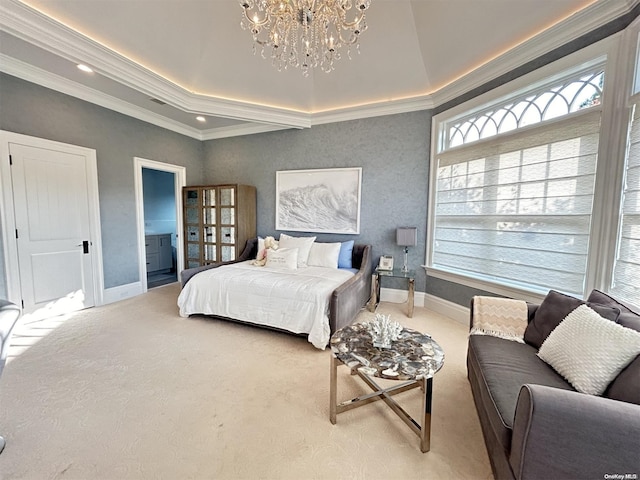 bedroom featuring carpet, ensuite bathroom, ornamental molding, a raised ceiling, and a notable chandelier