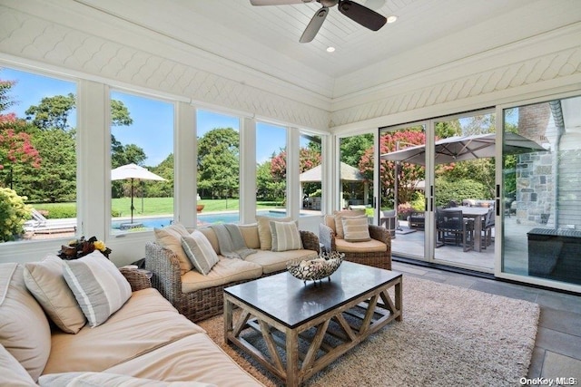 sunroom / solarium featuring ceiling fan