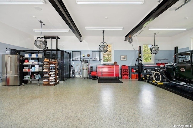 garage featuring stainless steel fridge