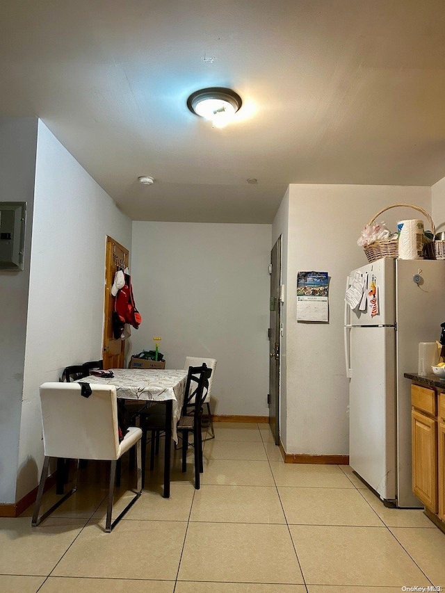 dining area with light tile patterned flooring and electric panel