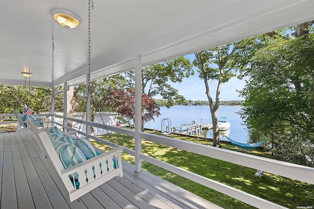 wooden terrace featuring a water view