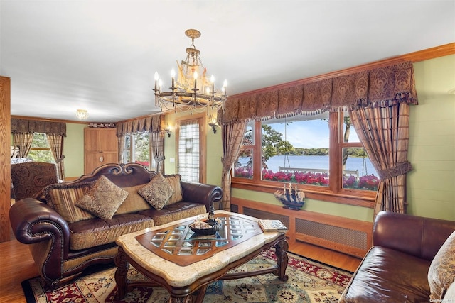 living room featuring a chandelier, wood-type flooring, and a water view