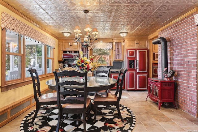 dining space featuring a wood stove, a notable chandelier, crown molding, and brick wall