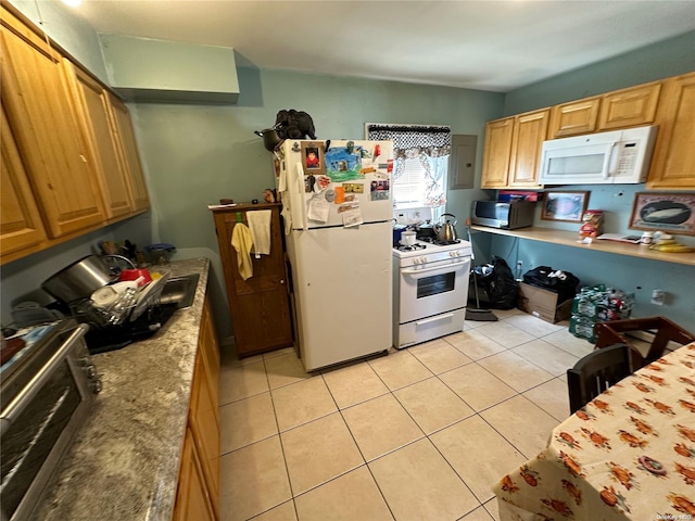 kitchen featuring light tile patterned flooring and white appliances