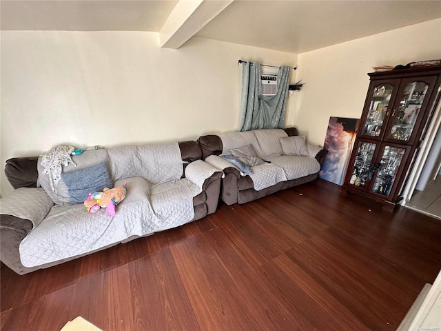 living room with beam ceiling, dark wood-type flooring, and an AC wall unit