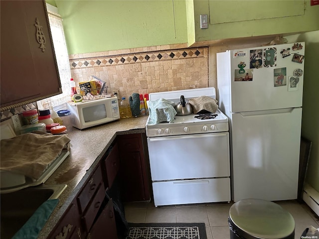 kitchen with sink, white appliances, dark brown cabinets, light tile patterned floors, and tile walls