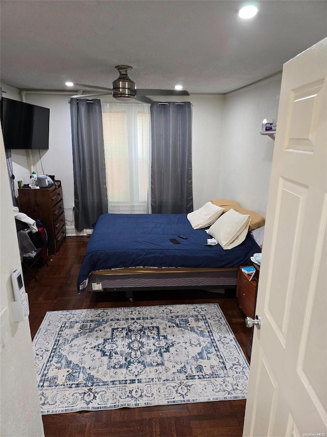 bedroom featuring ceiling fan and dark hardwood / wood-style flooring