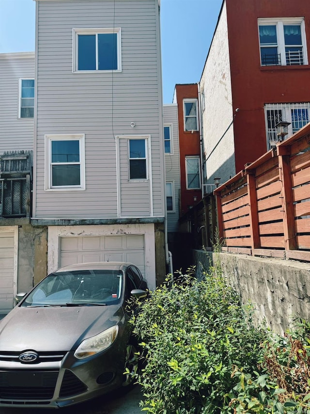 rear view of house featuring a garage