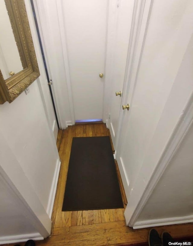 corridor with light hardwood / wood-style flooring