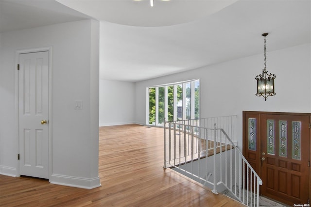 entrance foyer with hardwood / wood-style flooring and a notable chandelier