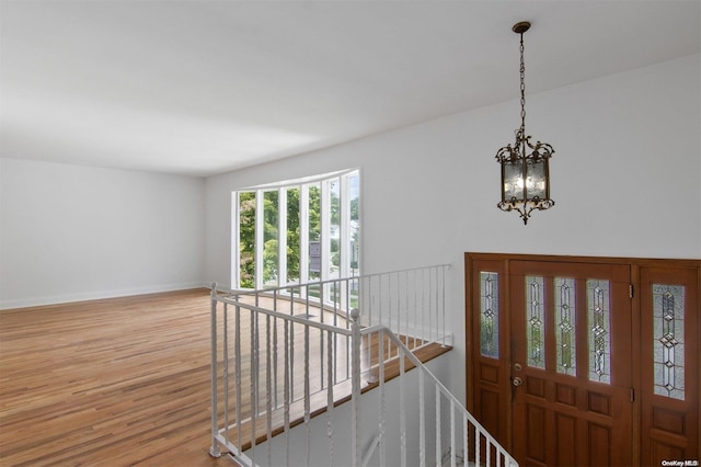 foyer with a notable chandelier and light wood-type flooring