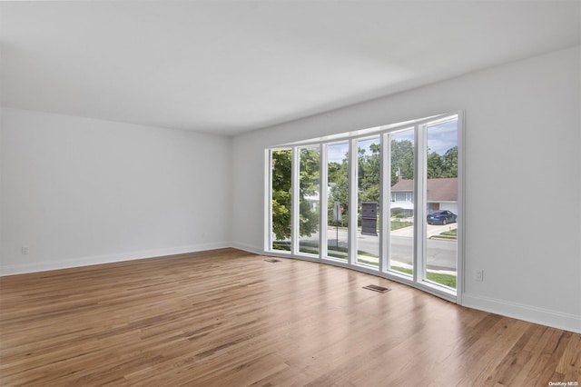 spare room featuring light wood-type flooring