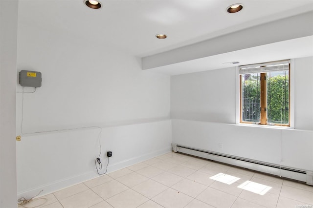 laundry area featuring light tile patterned flooring and a baseboard heating unit