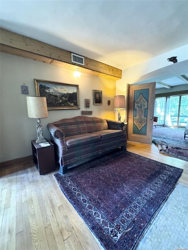 living room featuring hardwood / wood-style floors and beam ceiling