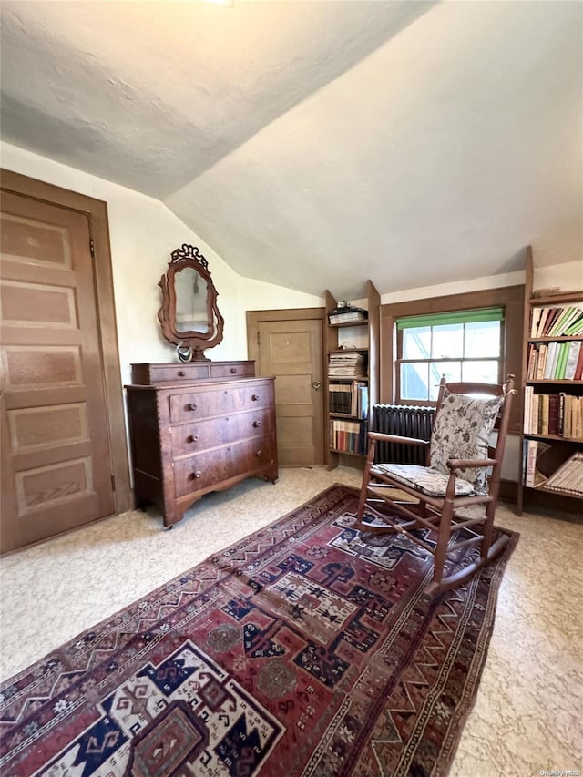 living area featuring light colored carpet and lofted ceiling