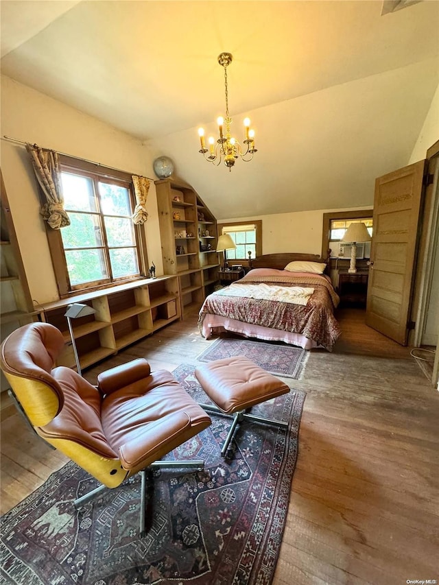 bedroom with a notable chandelier, vaulted ceiling, and hardwood / wood-style flooring