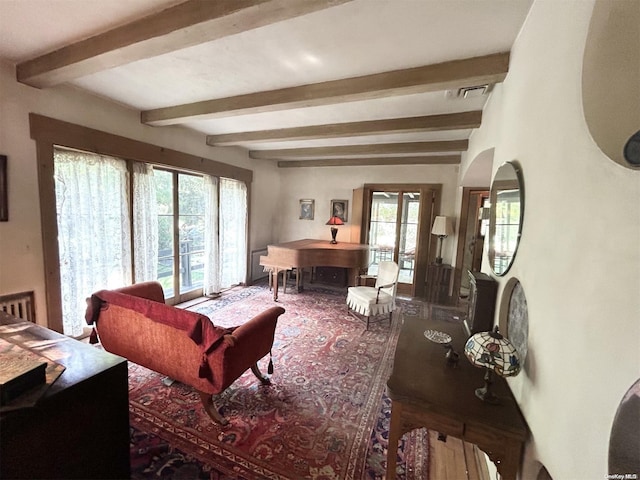 living room with beam ceiling and a wealth of natural light